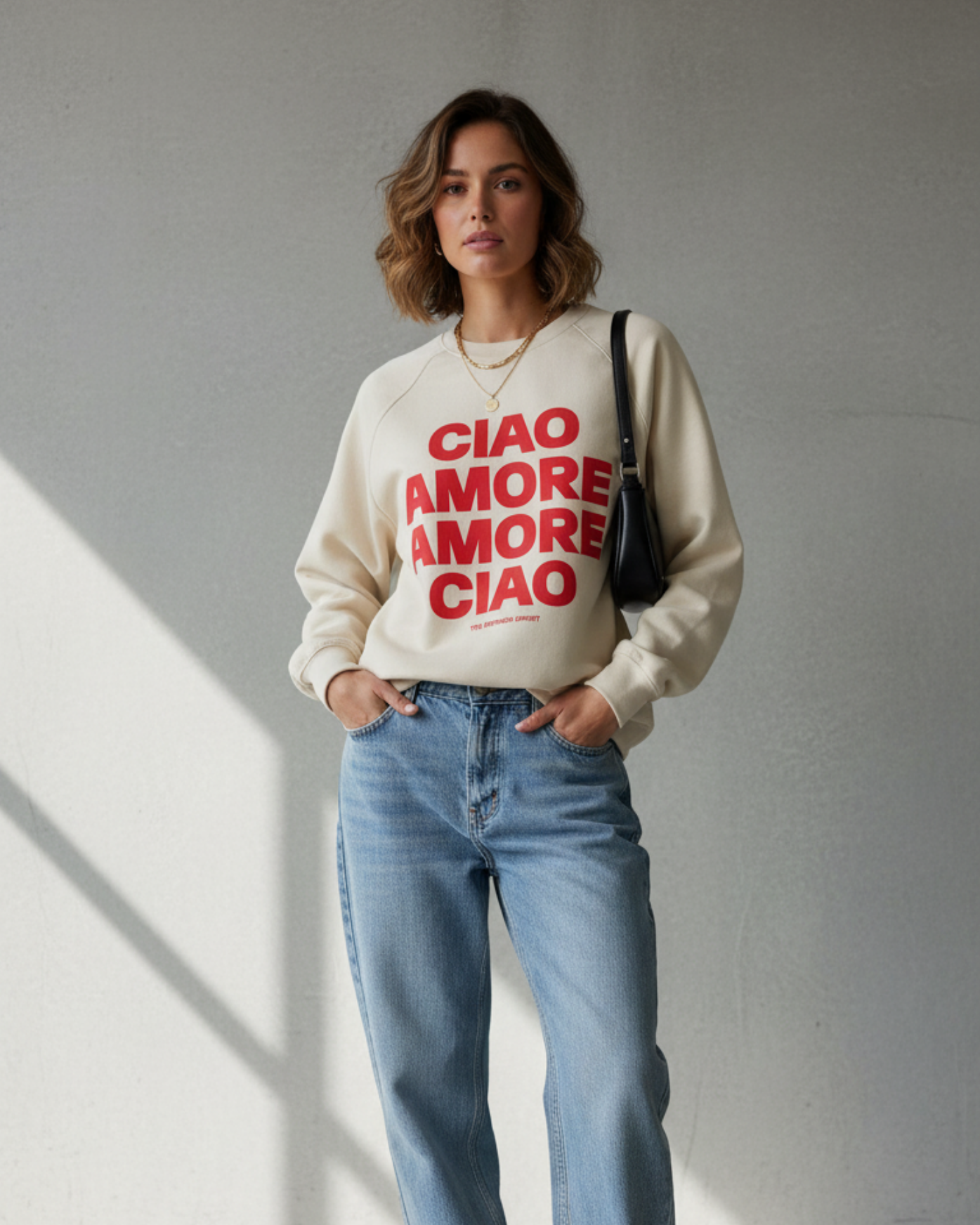 Woman wearing a white sweatshirt with red text, blue jeans, and white sneakers in a well-lit room.