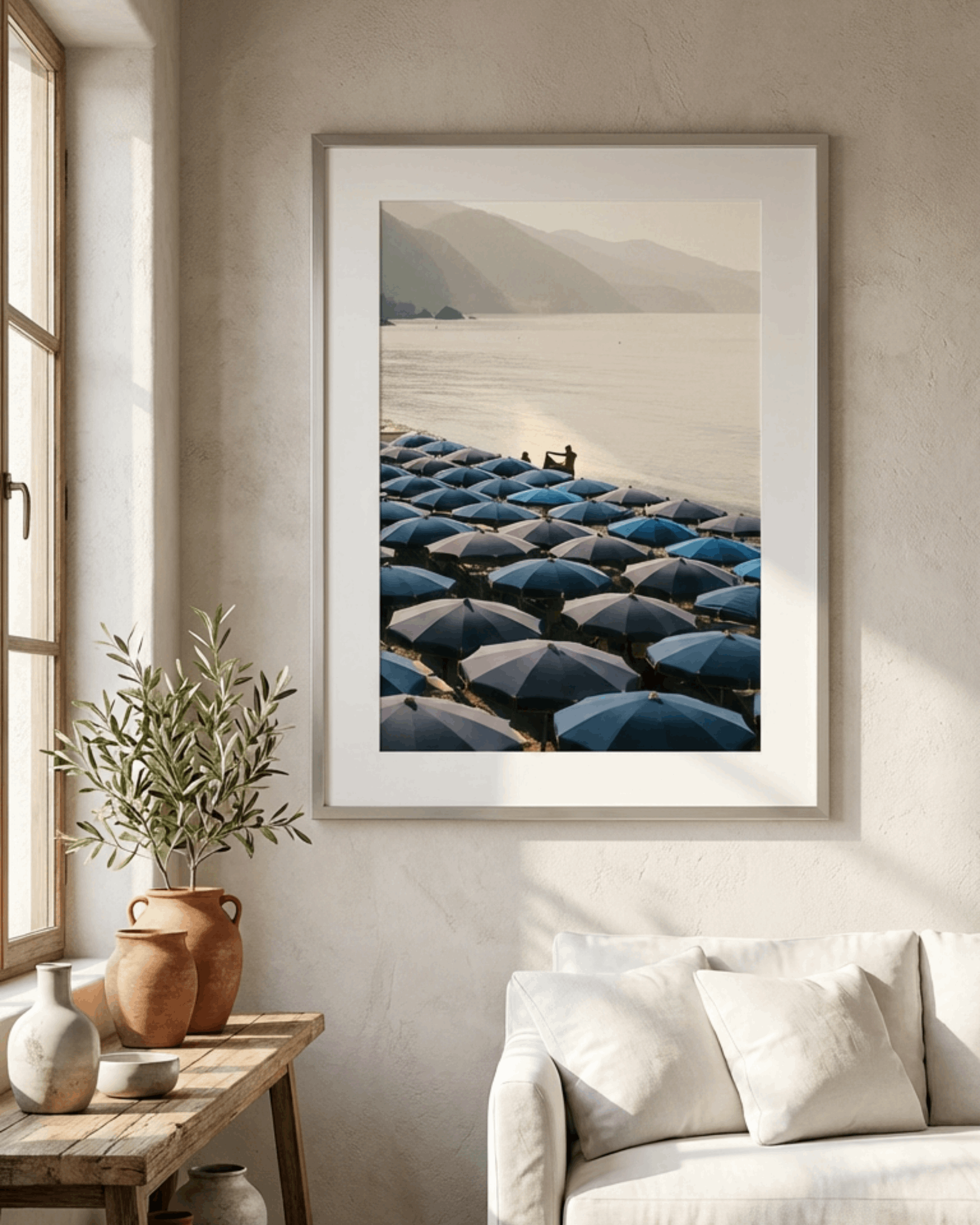 Framed artwork of a field with umbrellas in a living room setting.