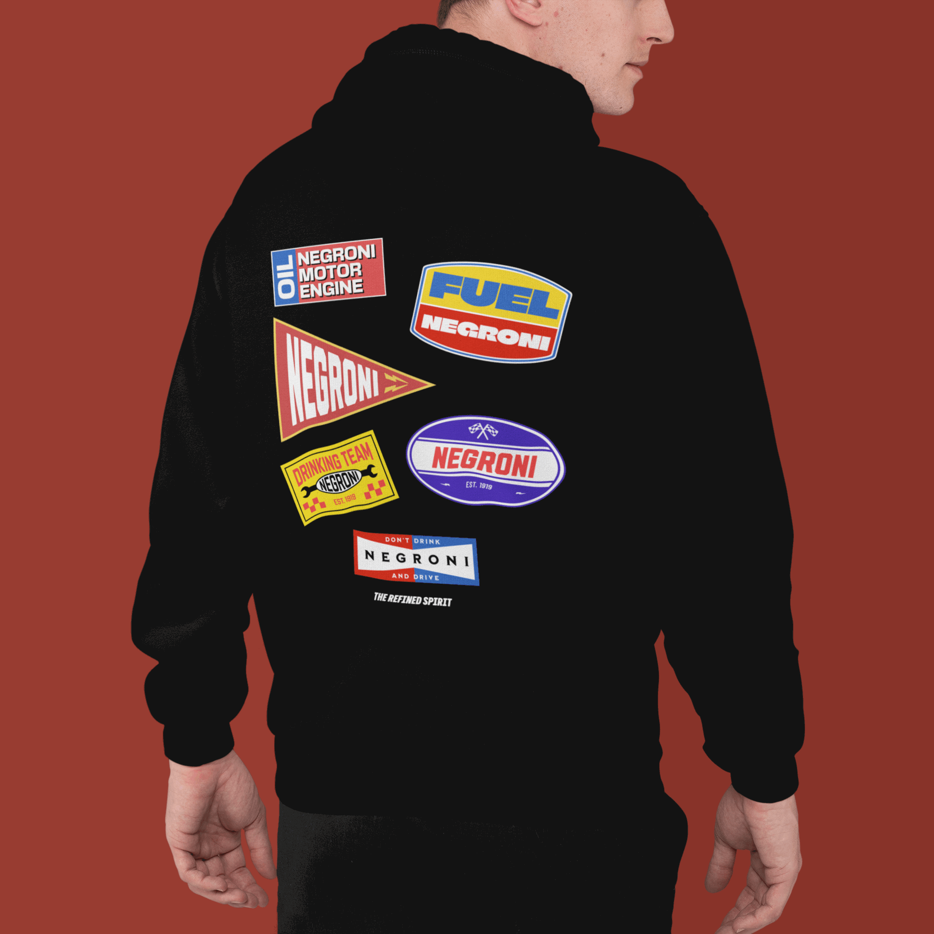 Black hoodie with colorful 'Negroni' brand logos on the back against a red background