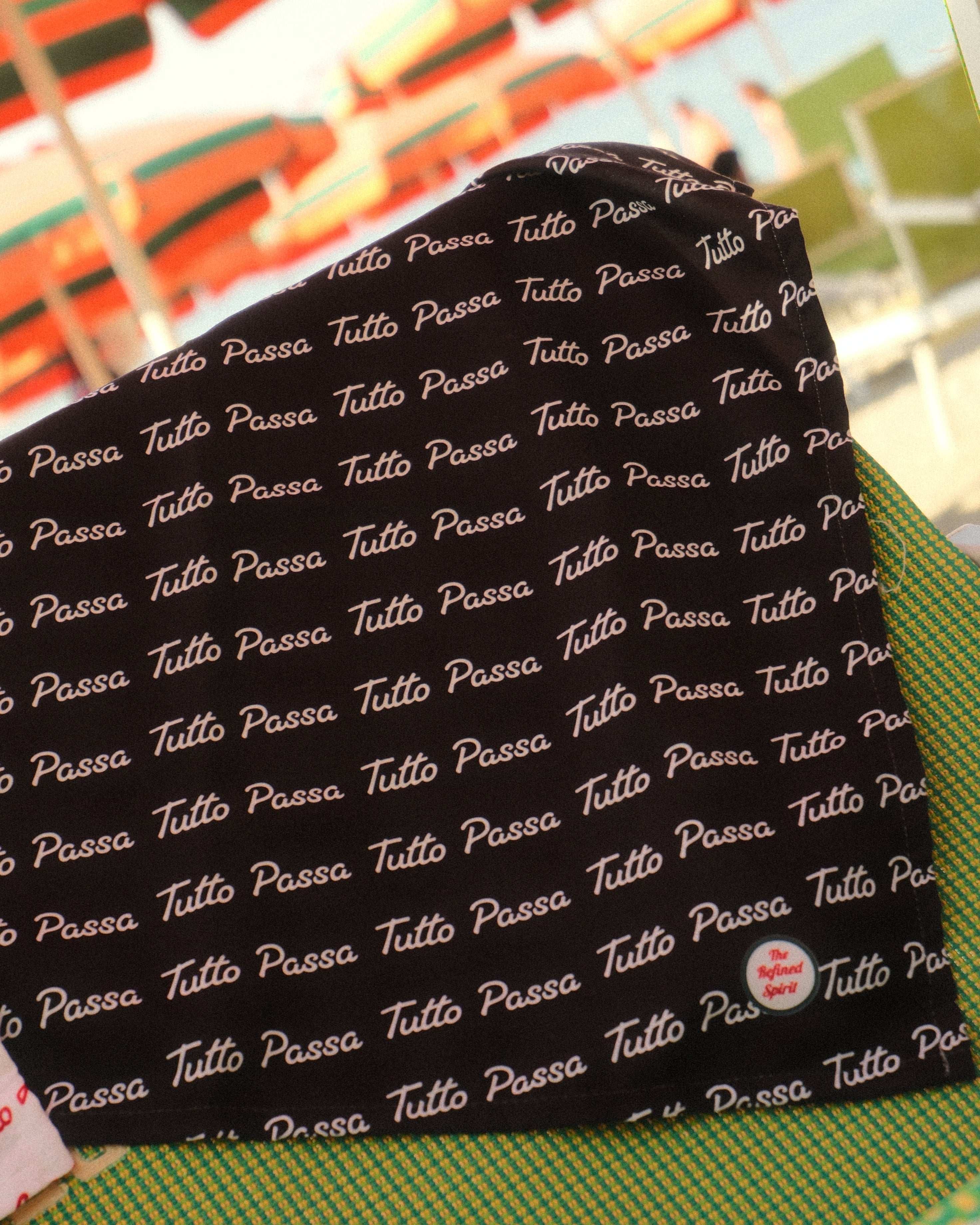 Black fabric with white text pattern on a colorful background