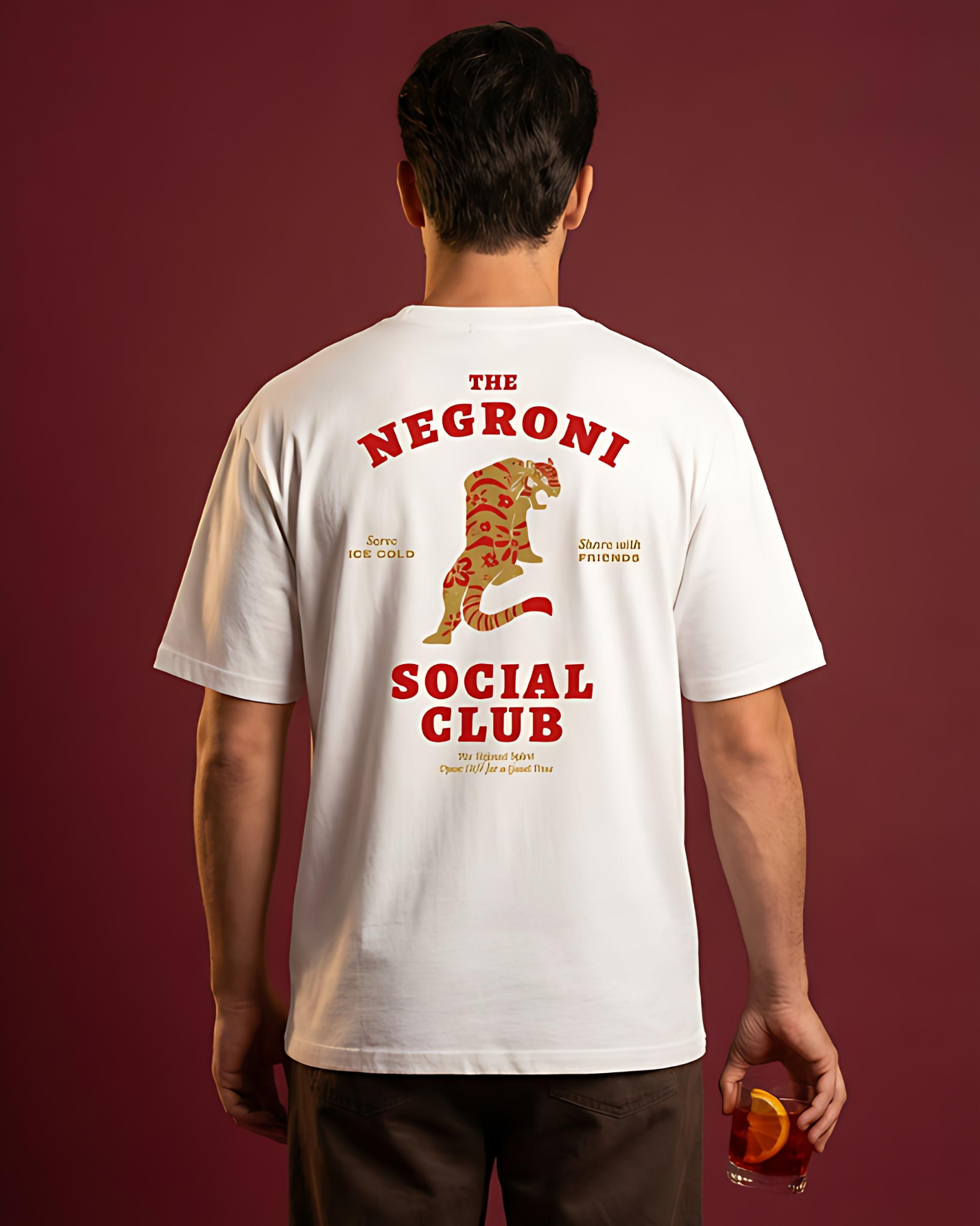 Person wearing a white t-shirt with 'The Negroni Social Club' design on the back against a red background