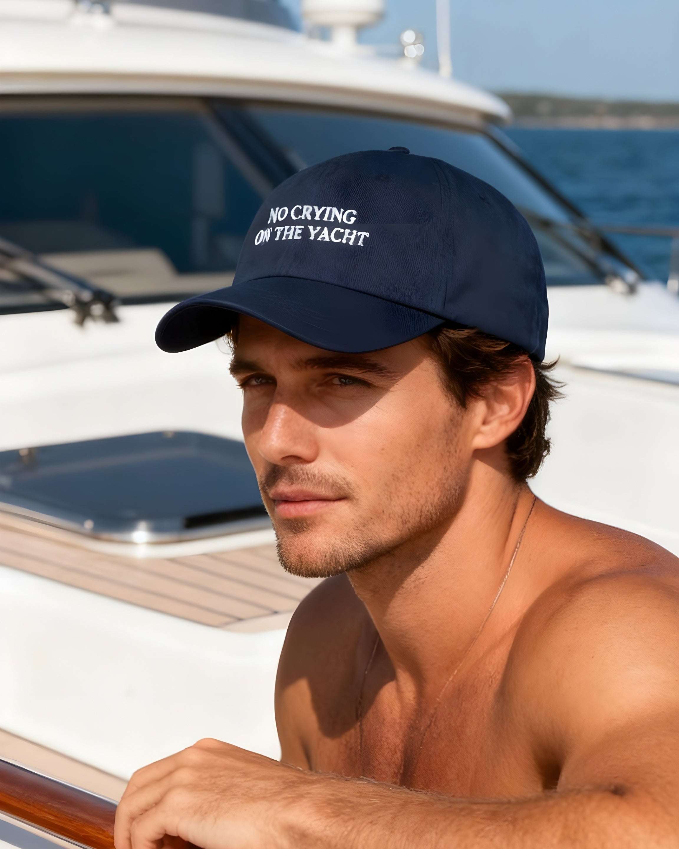 Man wearing a navy cap with text on a boat