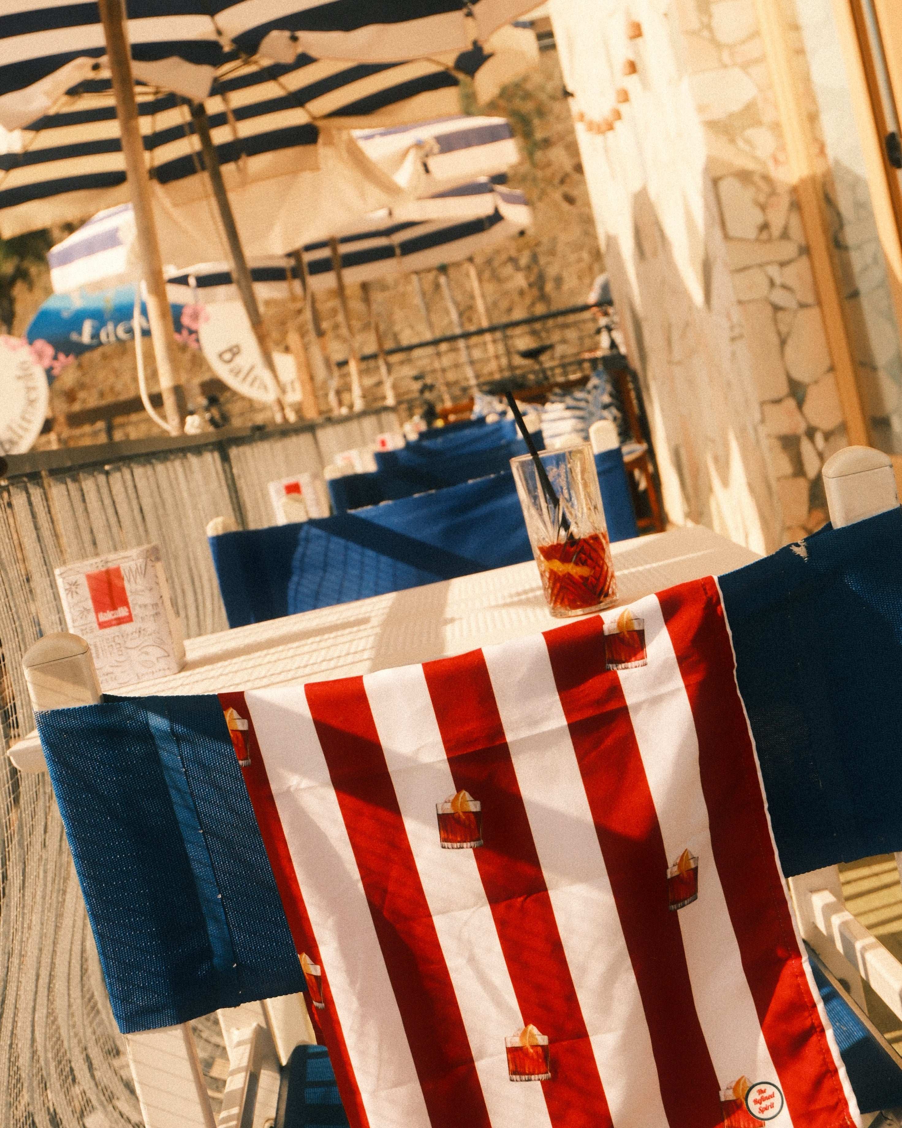 Red, white, and blue striped towel on a wooden surface with blurred background