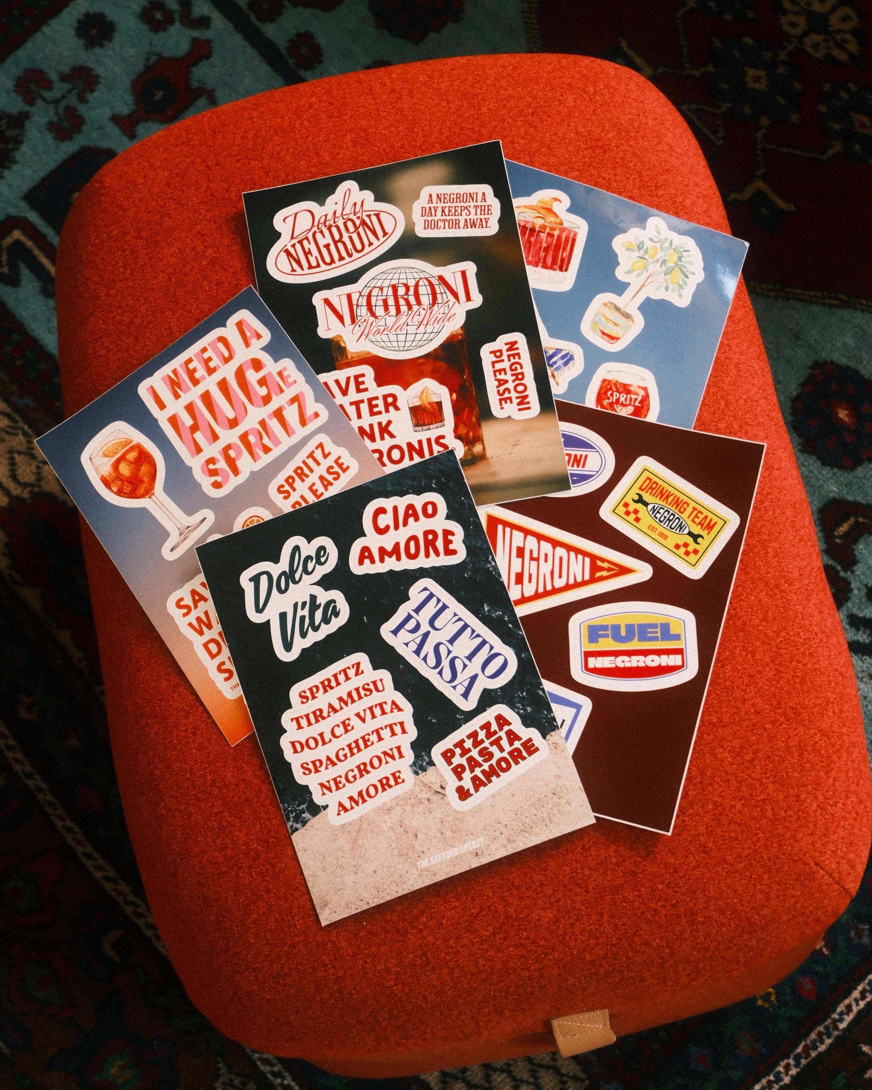 Collection of vintage-style stickers on an orange cushion with a patterned background