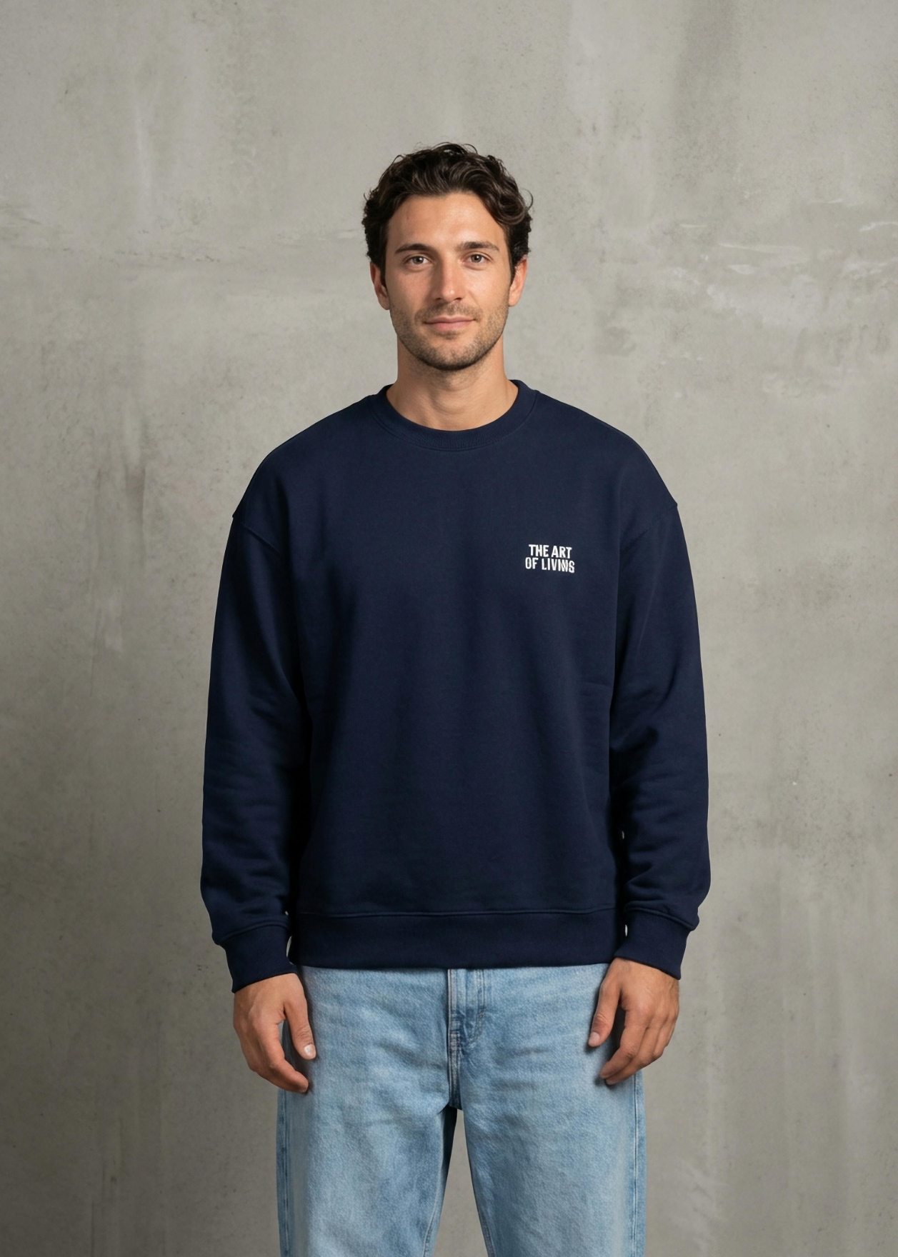 Man wearing a navy blue sweatshirt with a logo on a gray background
