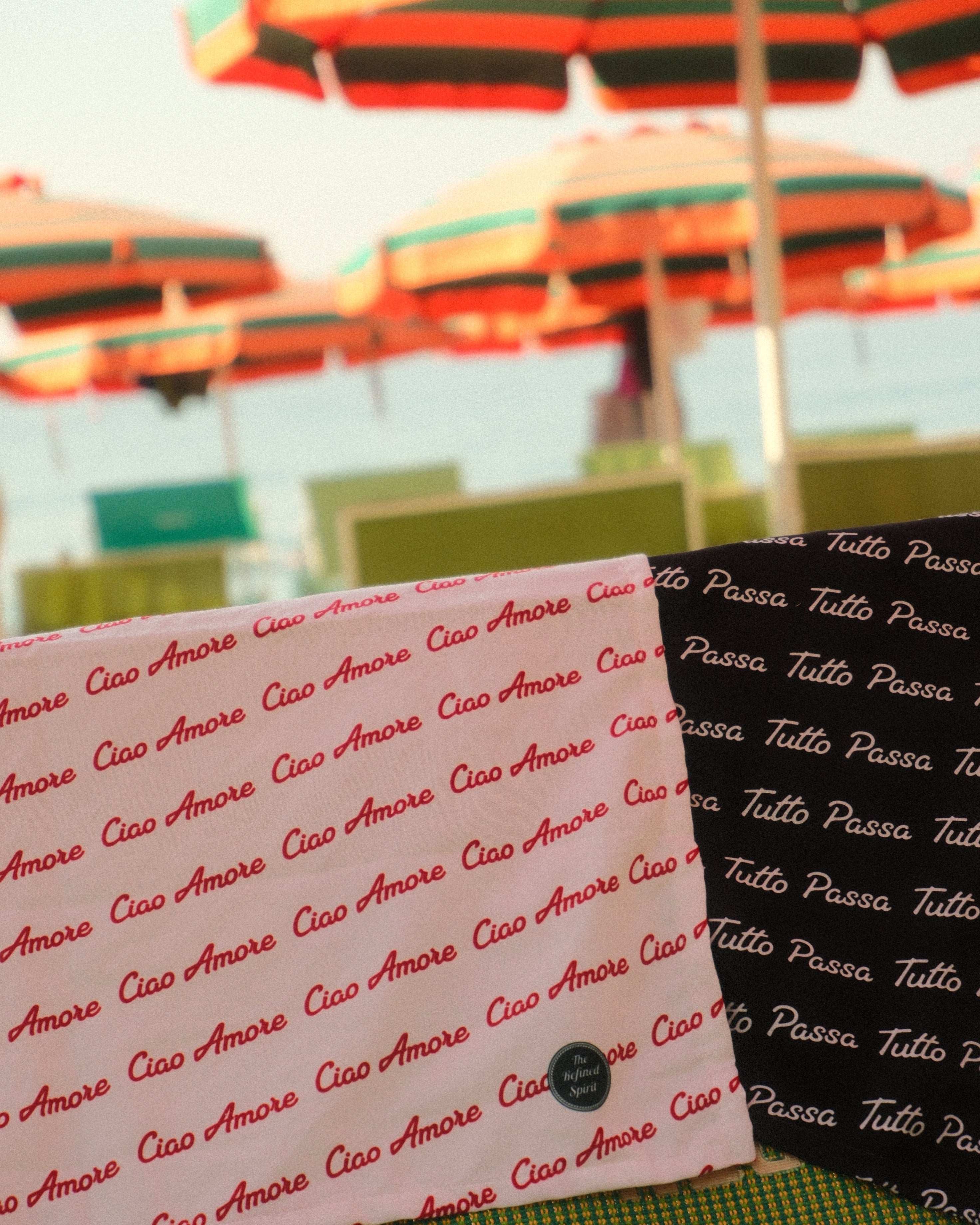 Textured fabric with 'Ciao Amore' pattern on a blurred background