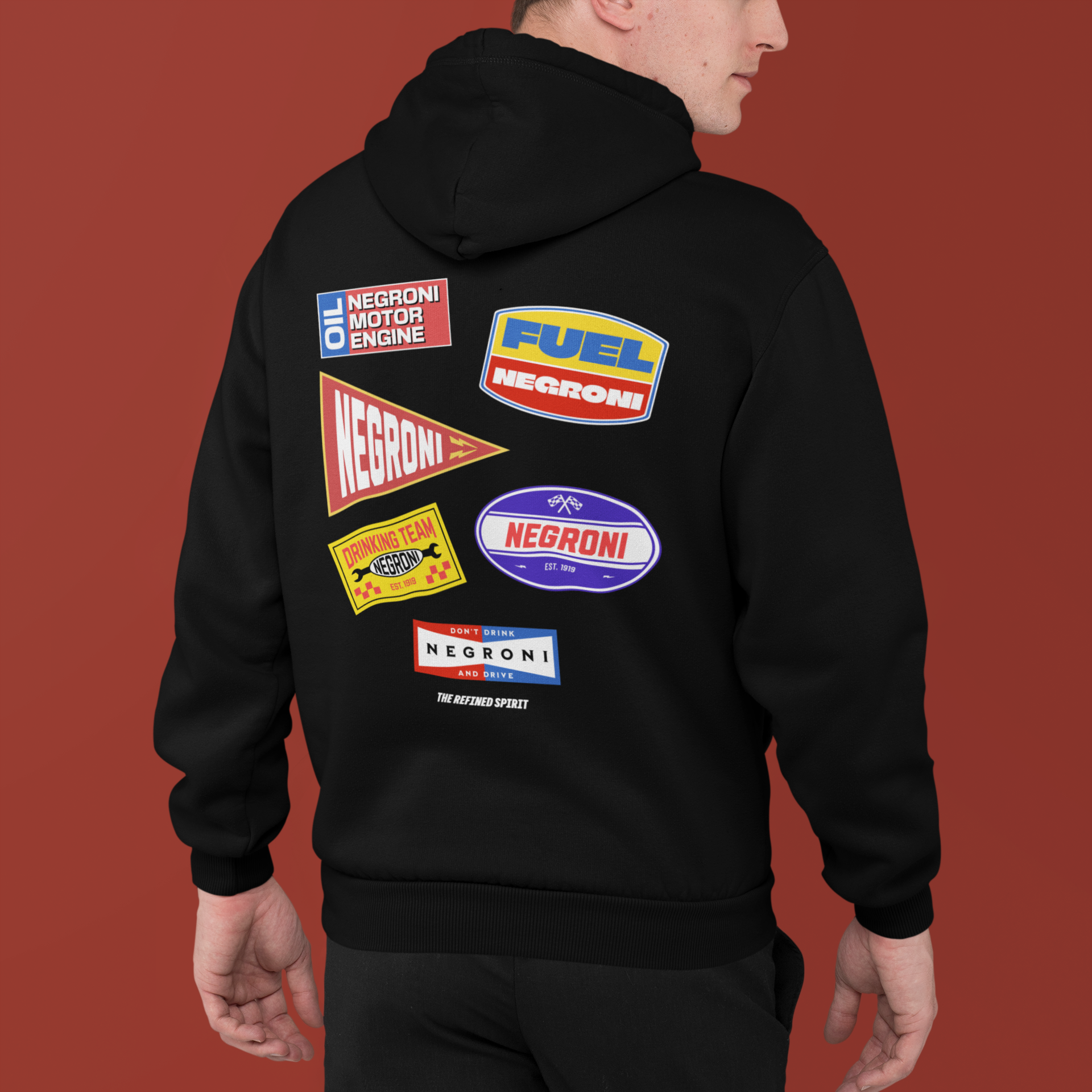 Black hoodie with colorful 'Negroni' brand logos on the back against a red background
