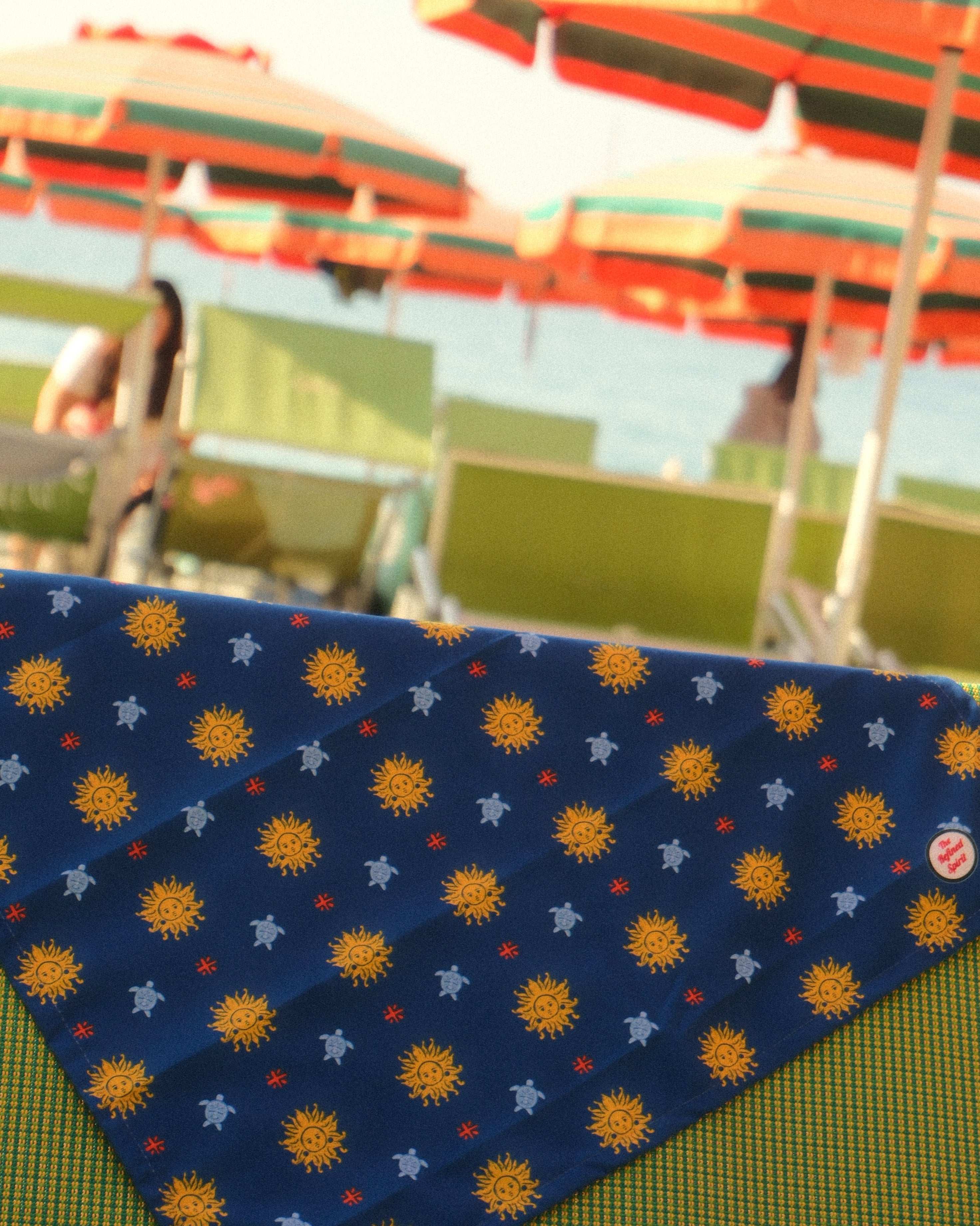Navy blue fabric with sun pattern on a green surface