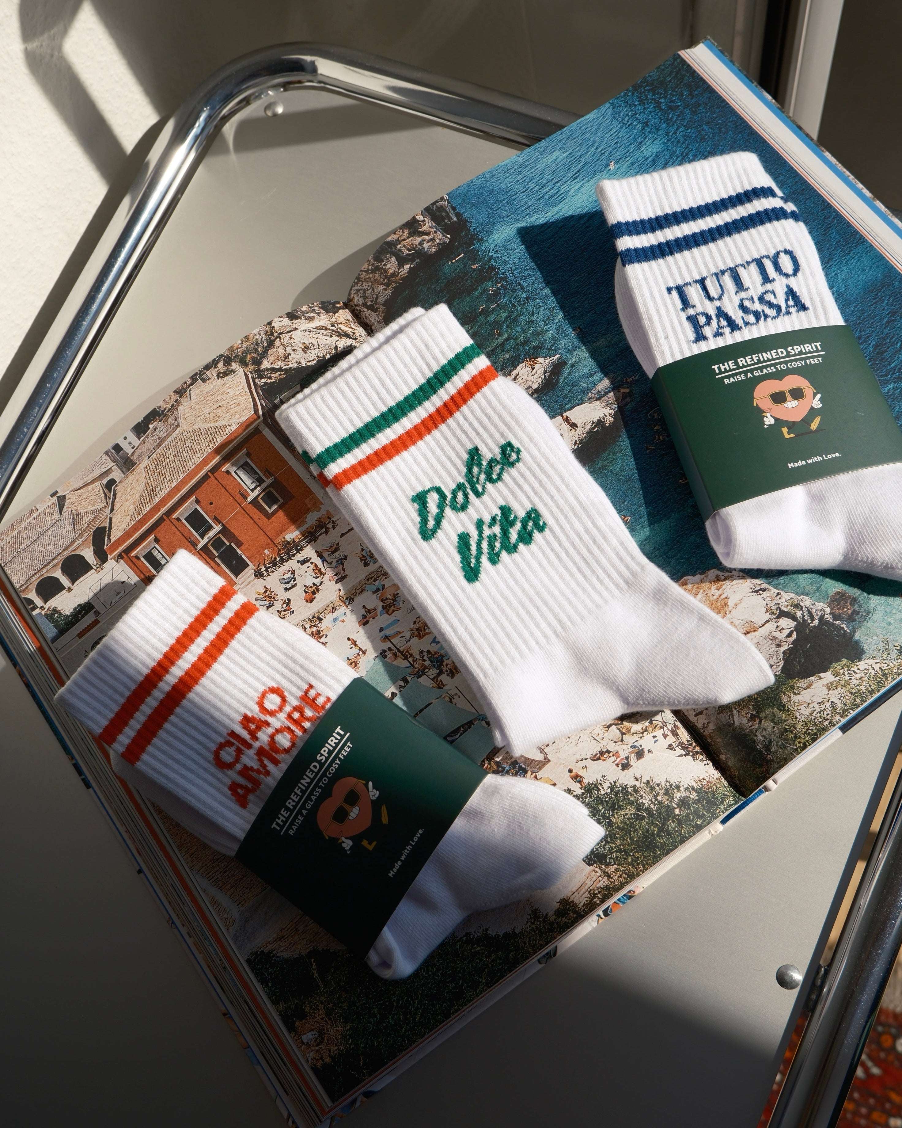 Three pairs of socks with visible branding on a magazine