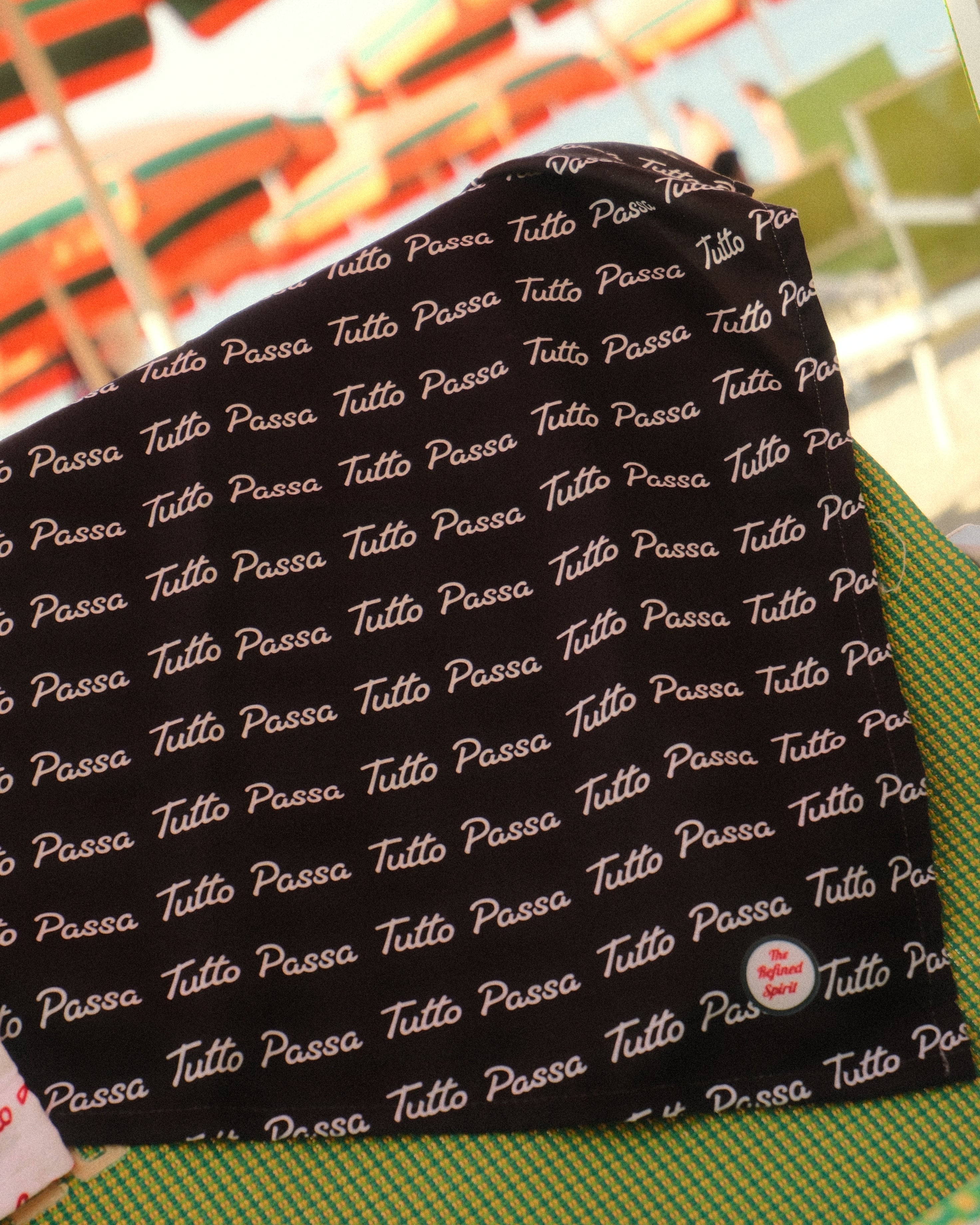 Black fabric with white text pattern on a colorful background