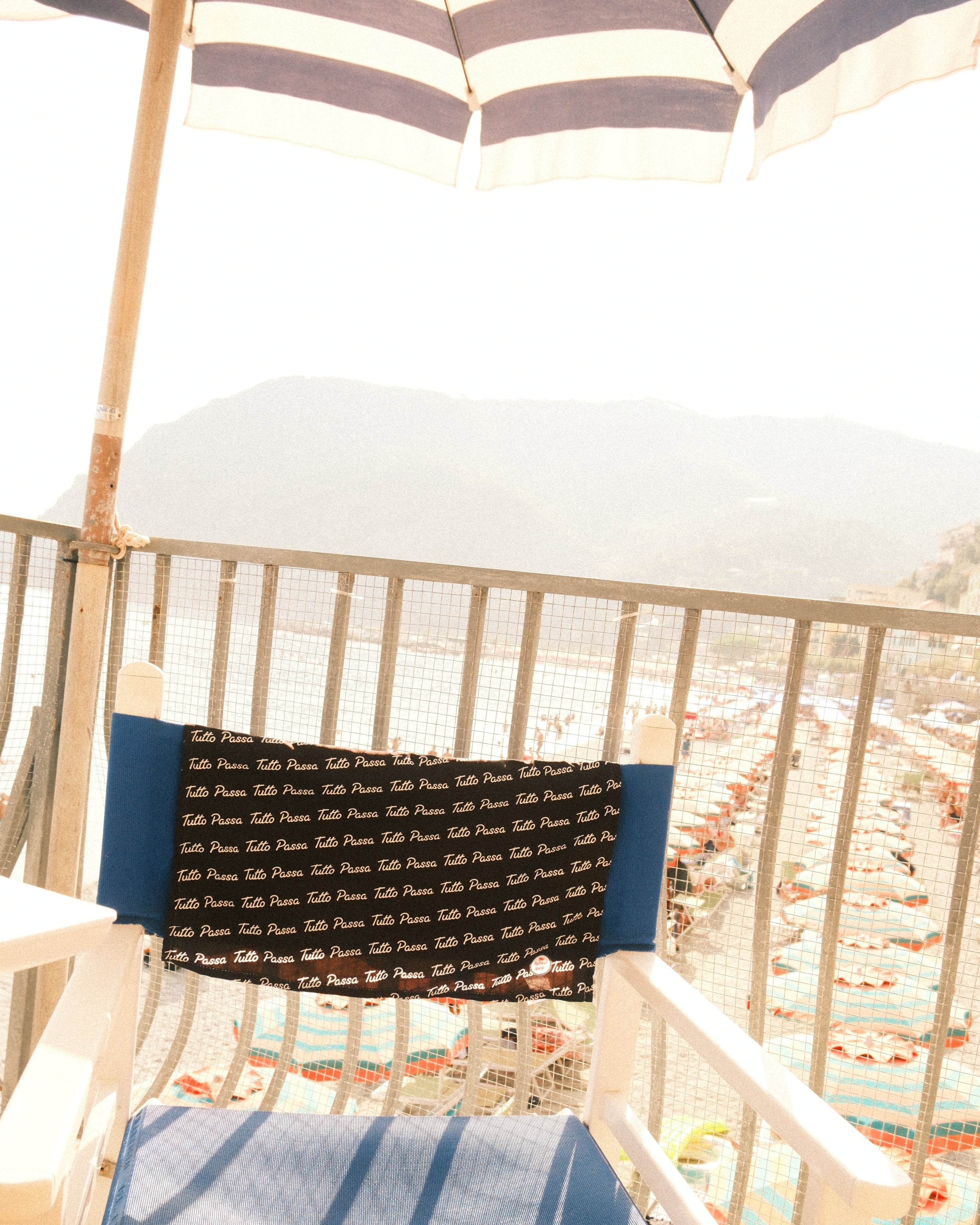Textiles hanging on a rack with a white background