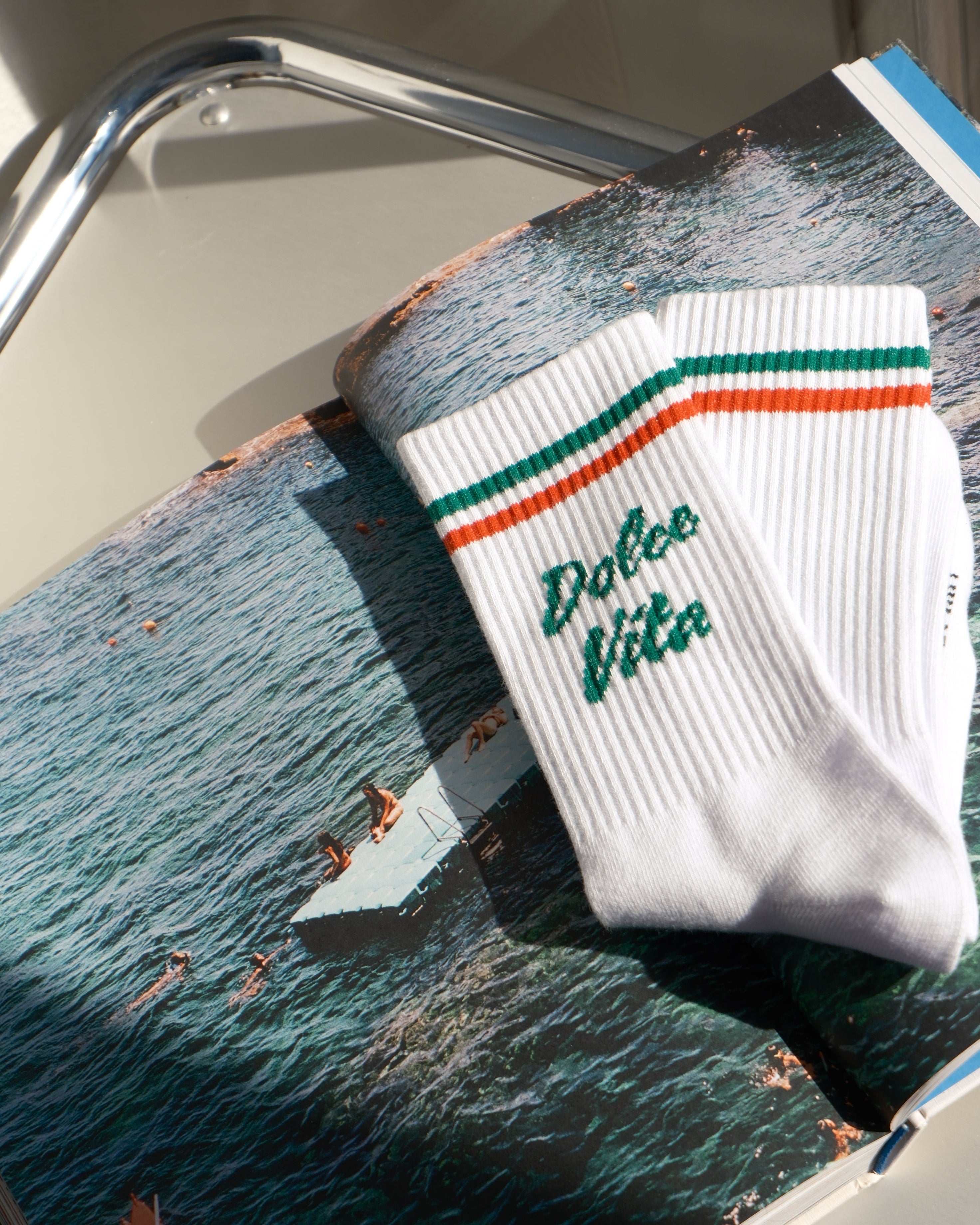 Towel with 'La Dolce Vita' branding on a boat with water and sky in the background