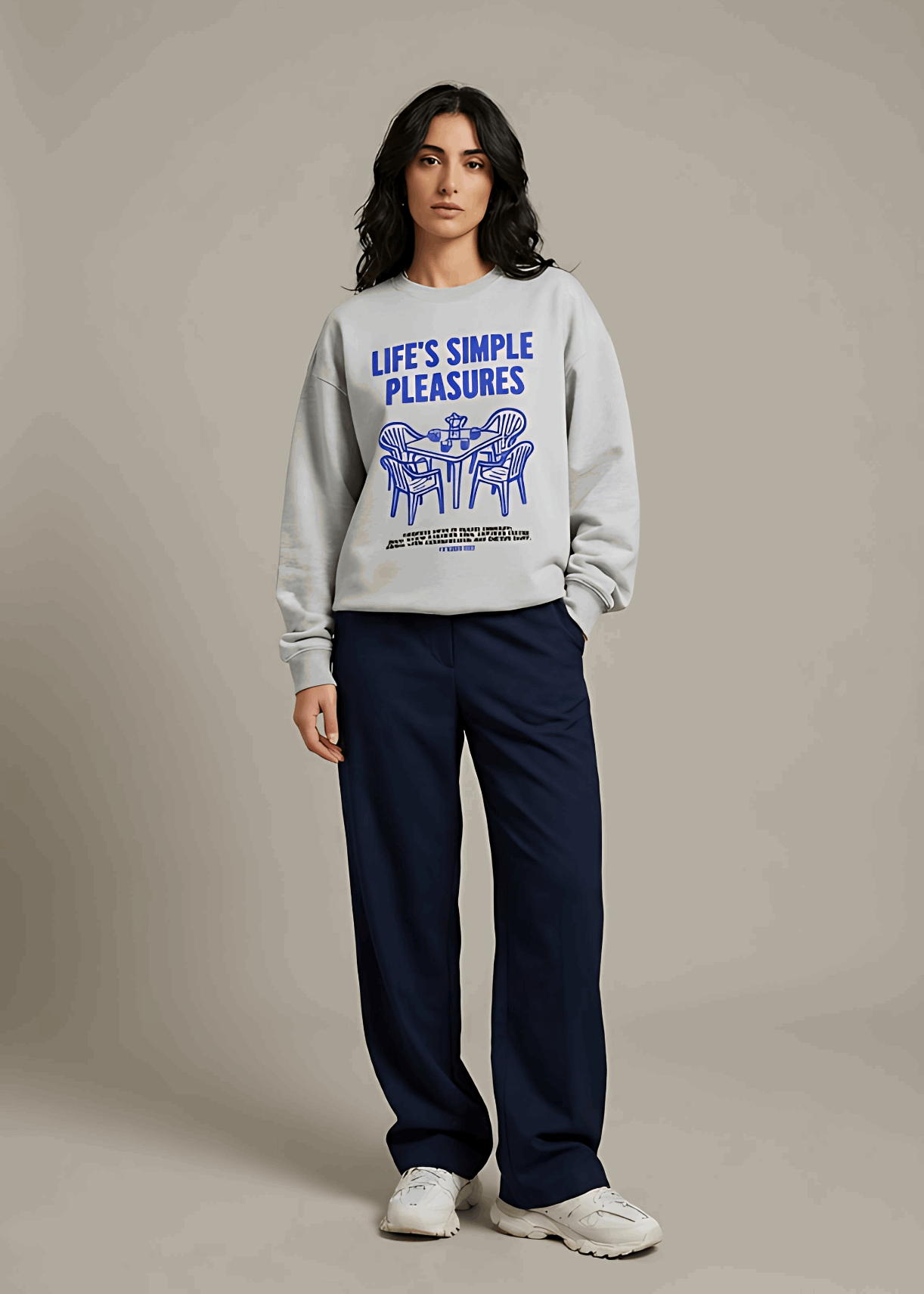 Person wearing a gray sweatshirt with text and graphics on a plain background