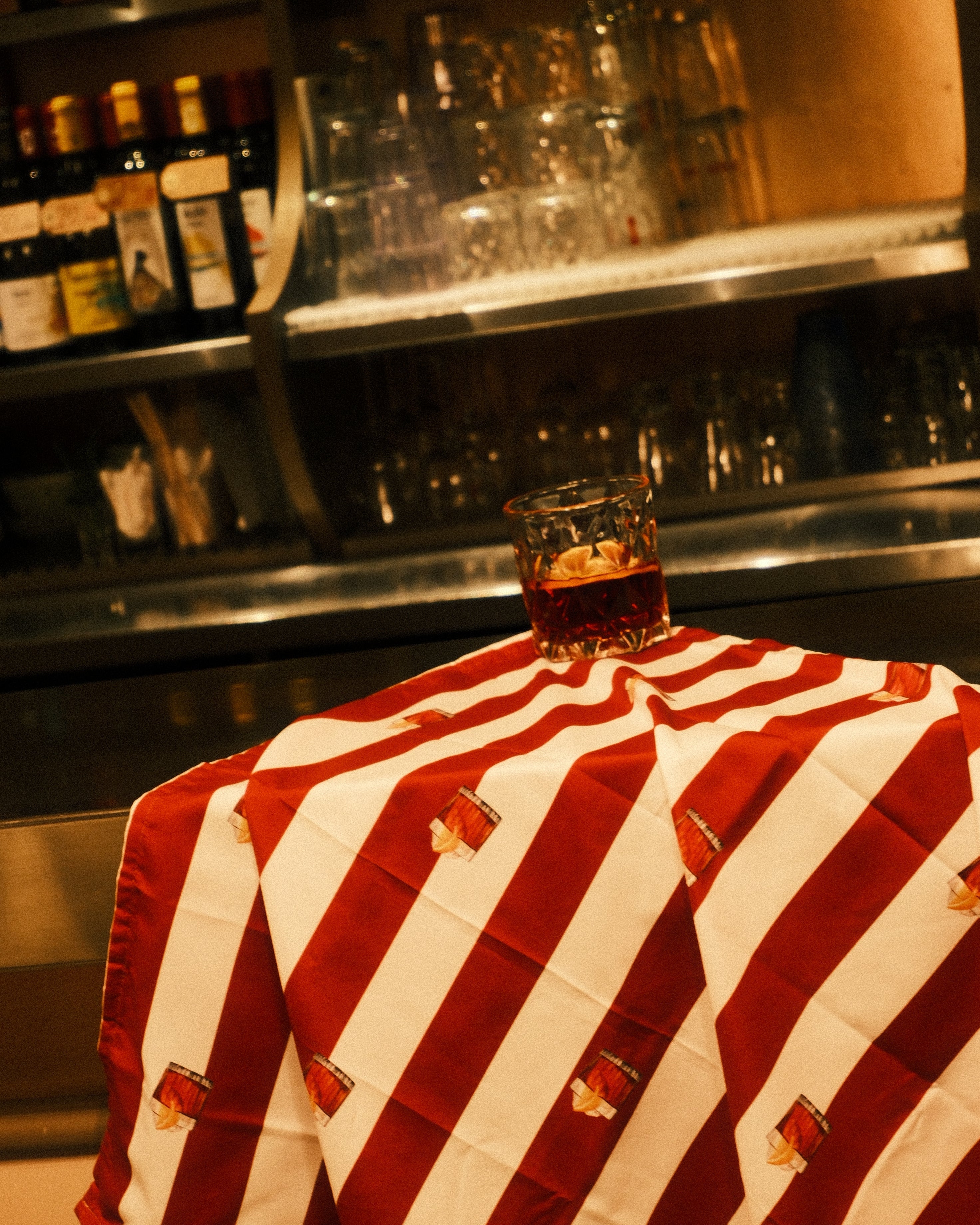 Red and white striped shirt with a blurred background of bottles