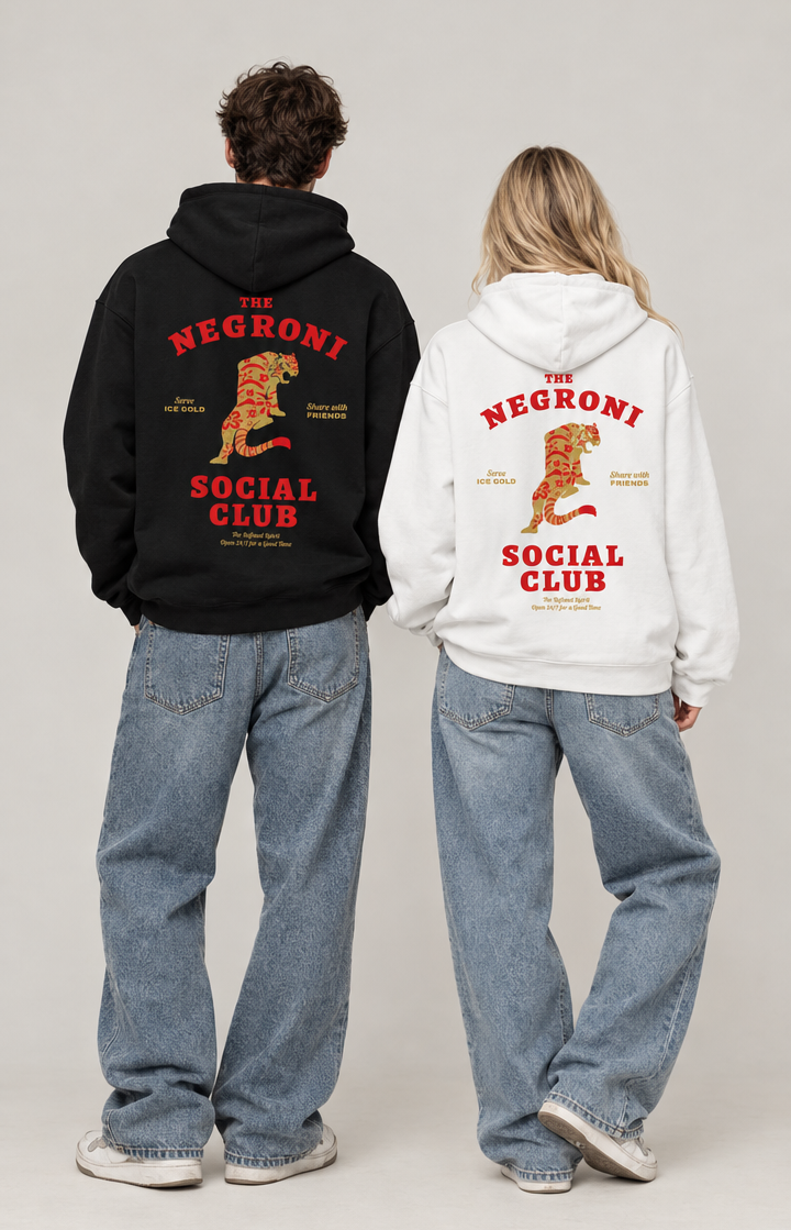 Two models shown from behind wearing oversized hoodies with large back graphics. The model on the left wears a black hoodie, and the model on the right wears a white hoodie.